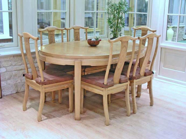 Solid ash oval dining table with 6 side chairs and 2 removable leaves.