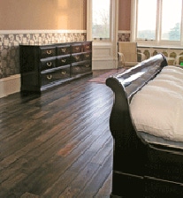 Bespoke bedroom furniture in solid rosewood showing 9 ft long chest and sleigh bed in solid rosewood.